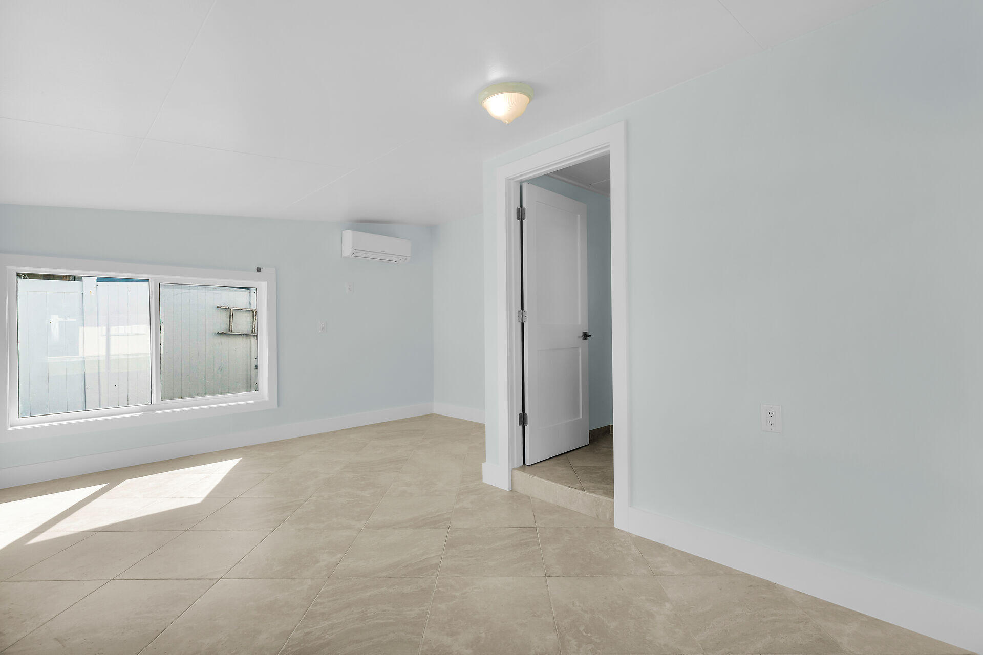 251 Azalea Street Tavernier, FL 33070 - Photo 31 of 58 an empty room with a natural light