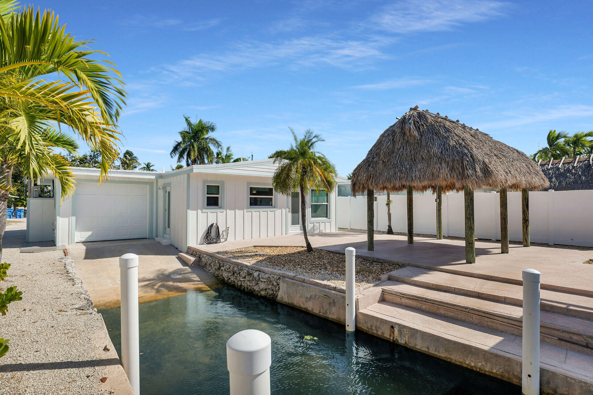 251 Azalea Street Tavernier, FL 33070 - Photo 42 of 58 a backyard of a house with table and chairs