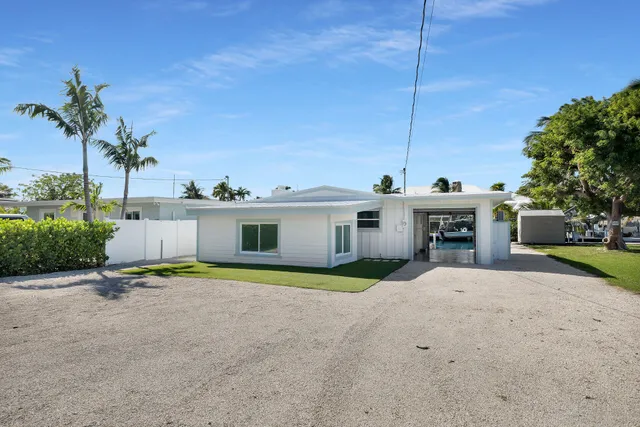 a view of a house with a patio and a yard