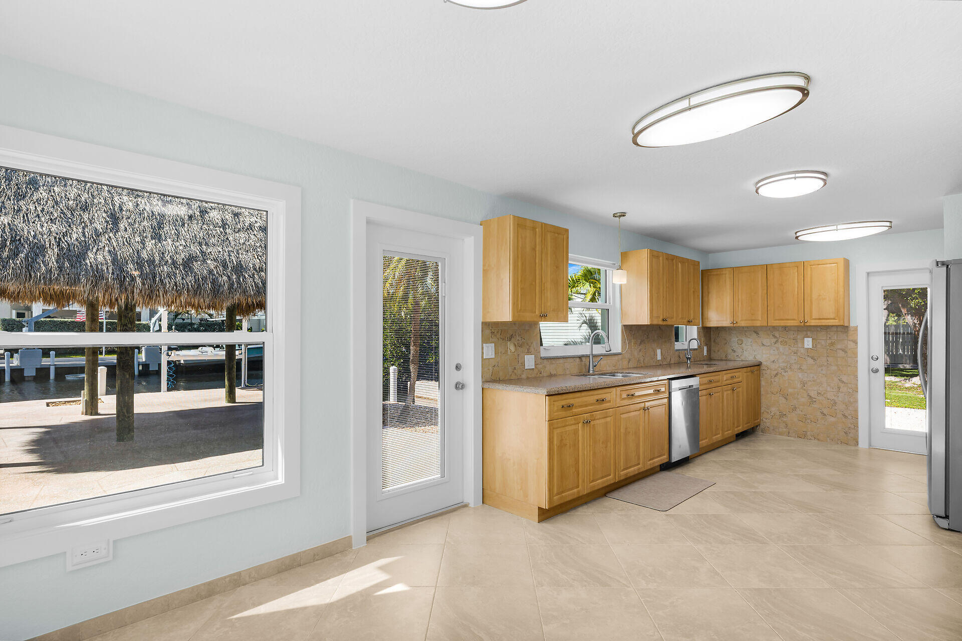 251 Azalea Street Tavernier, FL 33070 - Photo 10 of 58 a kitchen with stainless steel appliances granite countertop a stove and cabinets