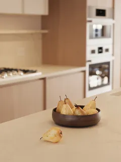 a kitchen with kitchen island granite countertop a sink and wooden cabinets