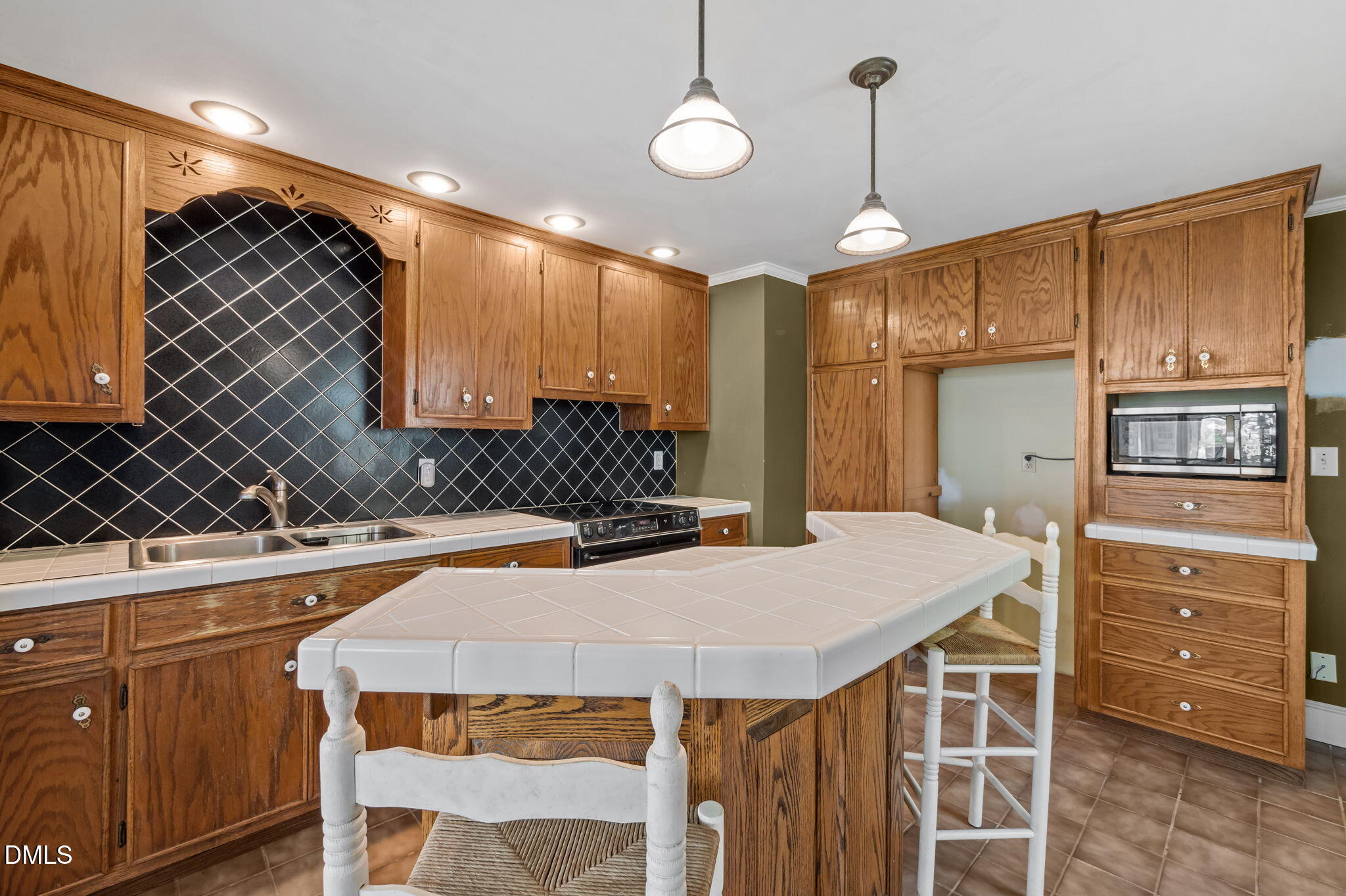 212 Thomas Humphries Road Roxboro, NC 27574 - Photo 34 of 56 a kitchen with a stove a refrigerator and a sink