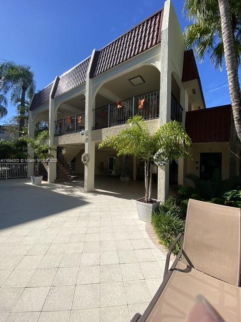 9301 Southwest 92nd Avenue, Unit A320 Miami, FL 33176 - Photo 1 of 15 a front view of a house with a yard