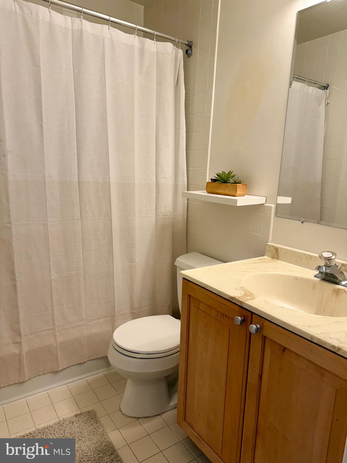 1434 Yellowwood Court Reston, VA 20190 - Photo 12 of 17 a bathroom with a granite countertop sink toilet and a mirror