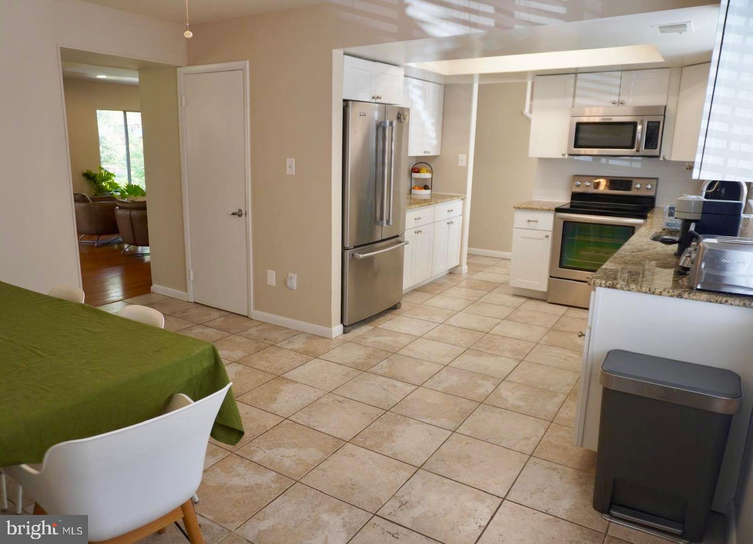 1434 Yellowwood Court Reston, VA 20190 - Photo 5 of 17 a kitchen with stainless steel appliances a sink cabinets and a refrigerator
