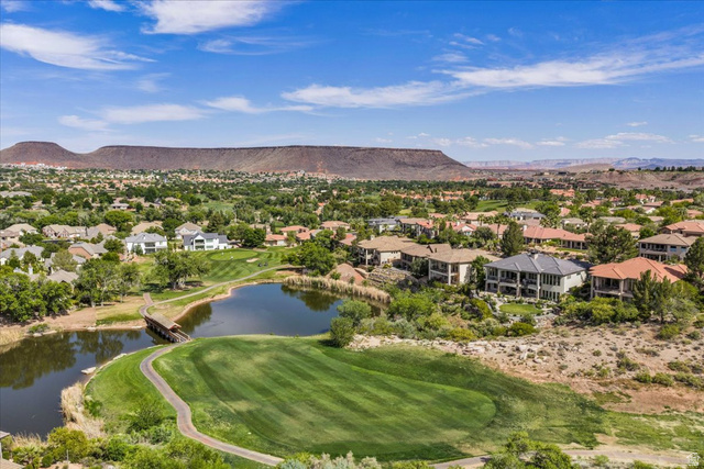 2608 Canyon Ridge Drive St. George, UT 84770 - Photo 83 of 86 Aerial perspective showcasing Sunbrook Communities with a golf course, natural water features, and expansive mountain scenery