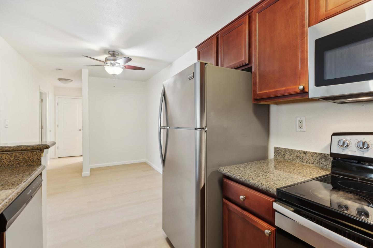 492 Dempsey Road, Unit 194 Milpitas, CA 95035 - Photo 11 of 27 a kitchen with stainless steel appliances granite countertop a refrigerator a stove and a sink with granite countertops