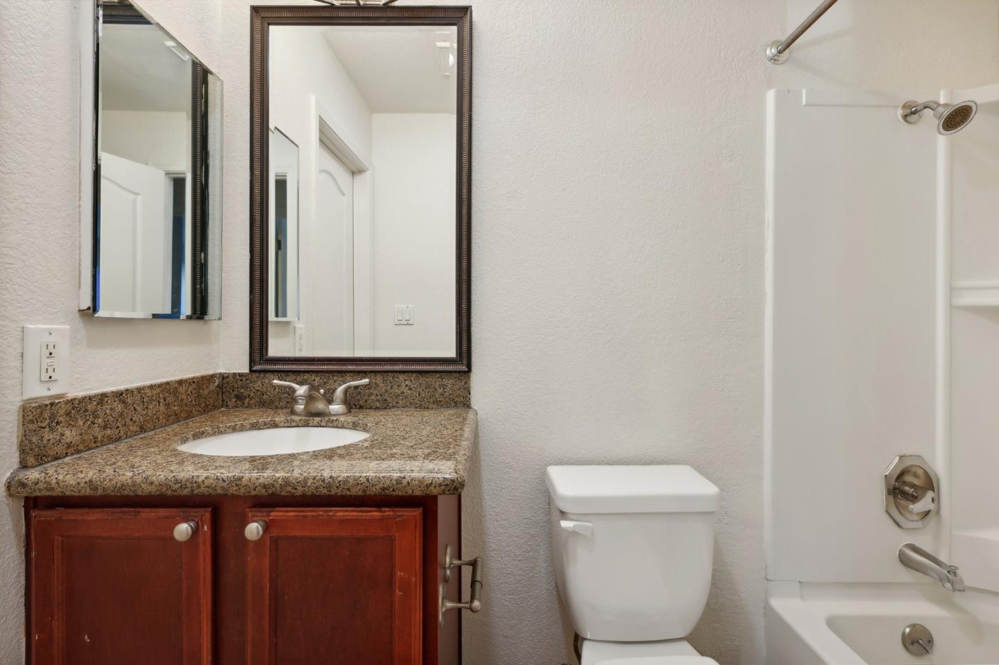 492 Dempsey Road, Unit 194 Milpitas, CA 95035 - Photo 14 of 27 a bathroom with a granite countertop sink and a mirror