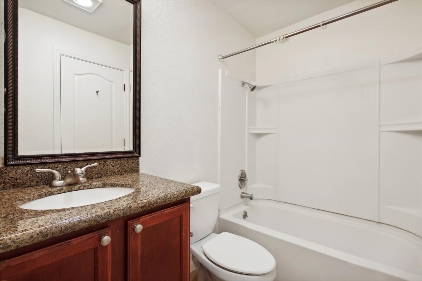 492 Dempsey Road, Unit 194 Milpitas, CA 95035 - Photo 15 of 27 a bathroom with a granite countertop sink toilet and shower