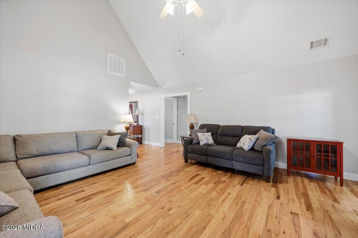 557 Aarons Circle Gray, GA 31032 - Photo 9 of 36 a living room with furniture and a wooden floor