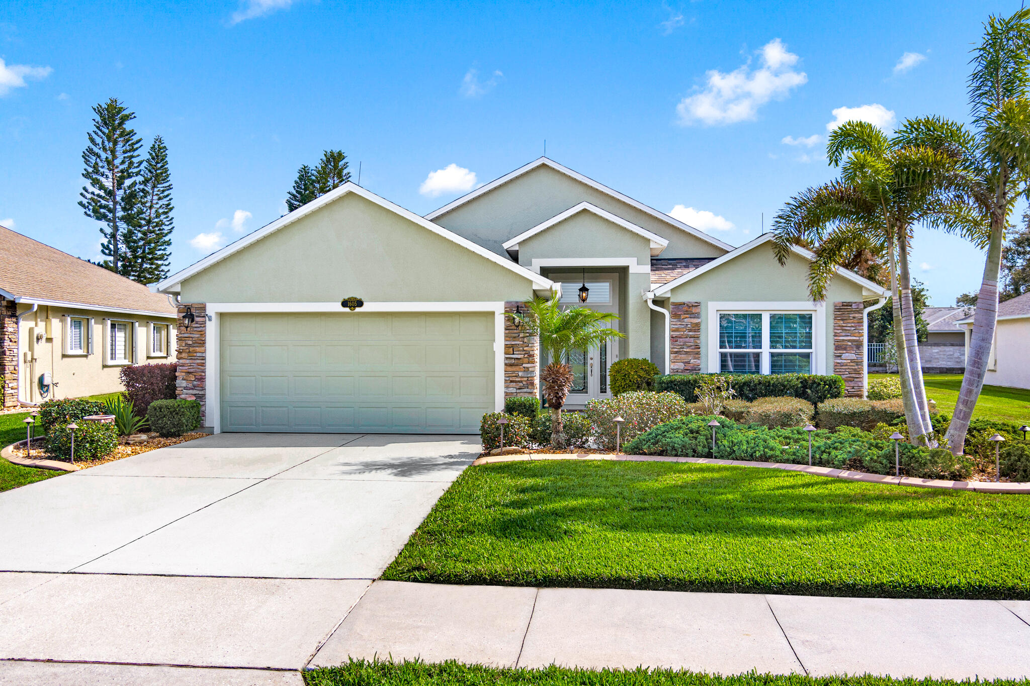 1605 Boca Rio Drive Melbourne, FL 32940 - Photo 1 of 55 a front view of a house with a yard and garage