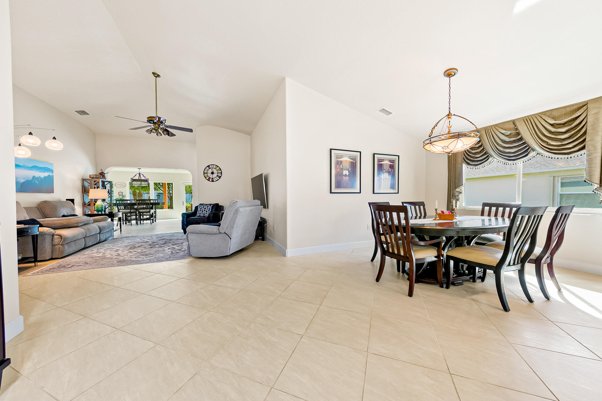1605 Boca Rio Drive Melbourne, FL 32940 - Photo 11 of 55 a living room with furniture a table and a chandelier