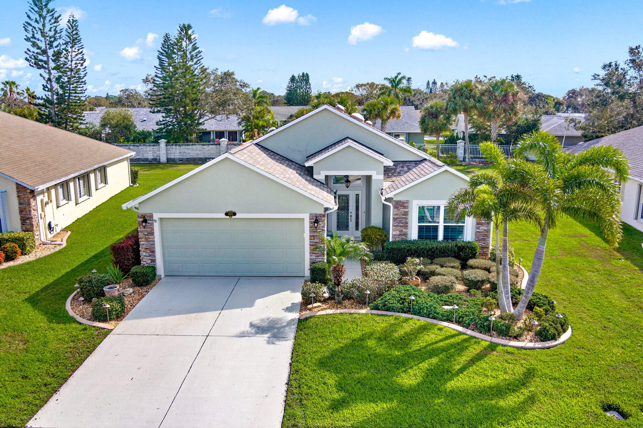 1605 Boca Rio Drive Melbourne, FL 32940 - Photo 2 of 55 a aerial view of a house with yard and green space