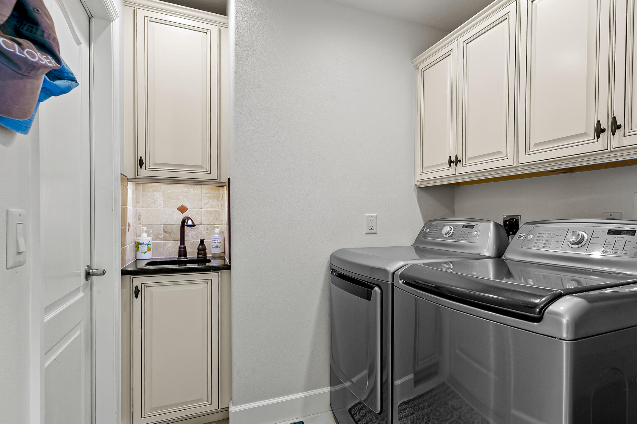 1605 Boca Rio Drive Melbourne, FL 32940 - Photo 27 of 55 a kitchen with stainless steel appliances granite countertop a stove a sink and a refrigerator with white cabinets