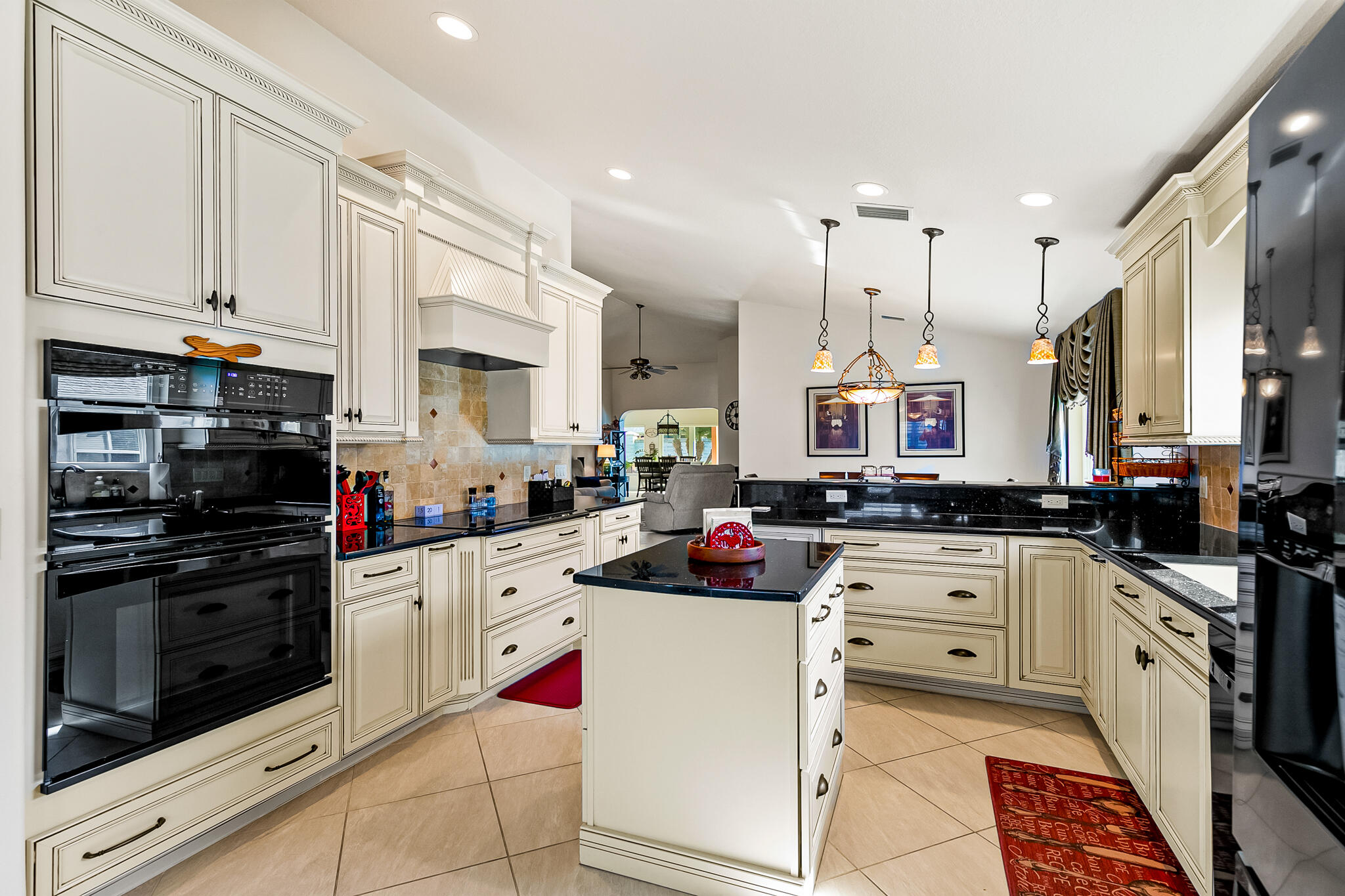 1605 Boca Rio Drive Melbourne, FL 32940 - Photo 6 of 55 a kitchen with stainless steel appliances granite countertop a sink and cabinets