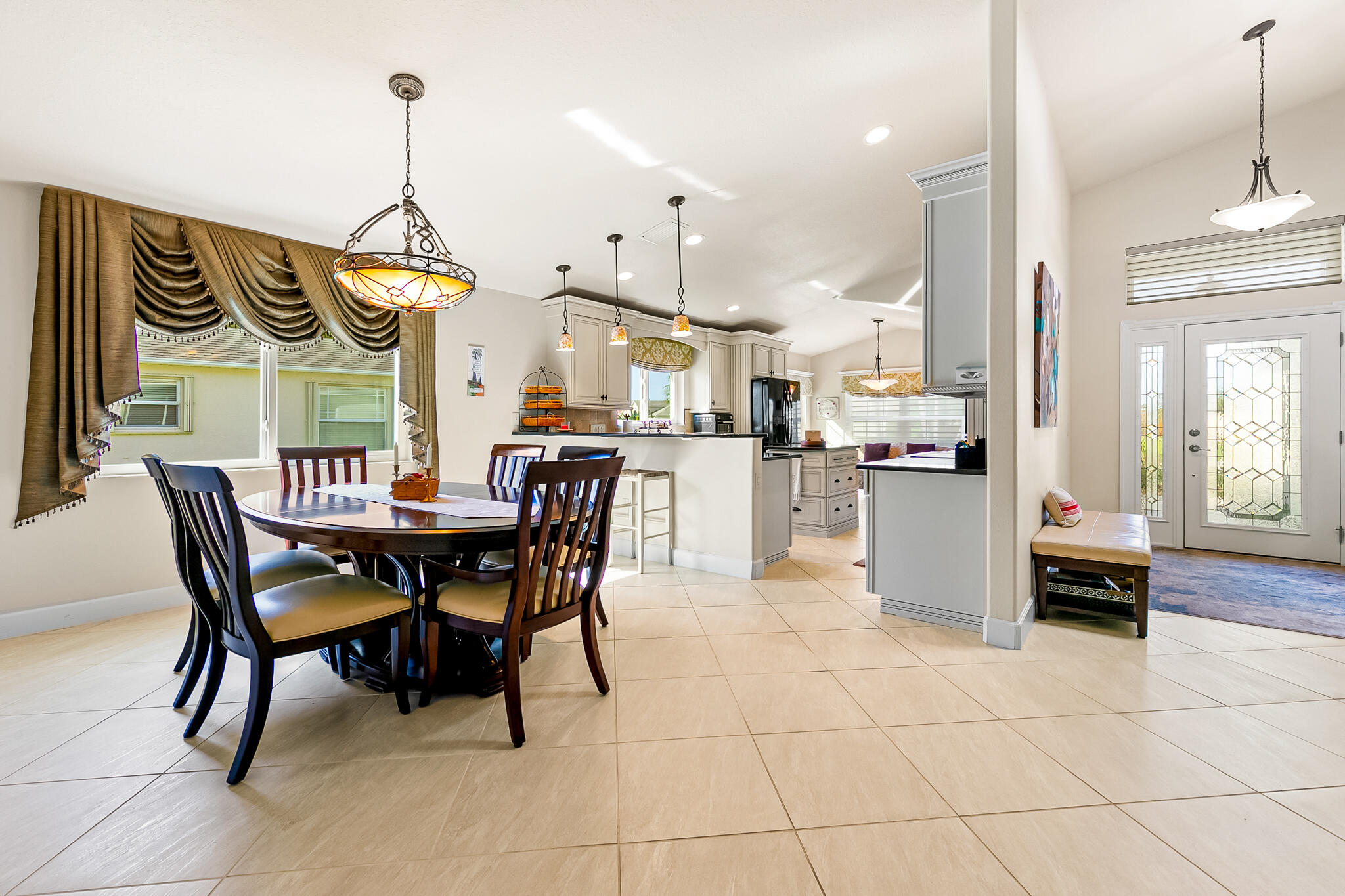 1605 Boca Rio Drive Melbourne, FL 32940 - Photo 8 of 55 a dining area with a table chairs and a kitchen view