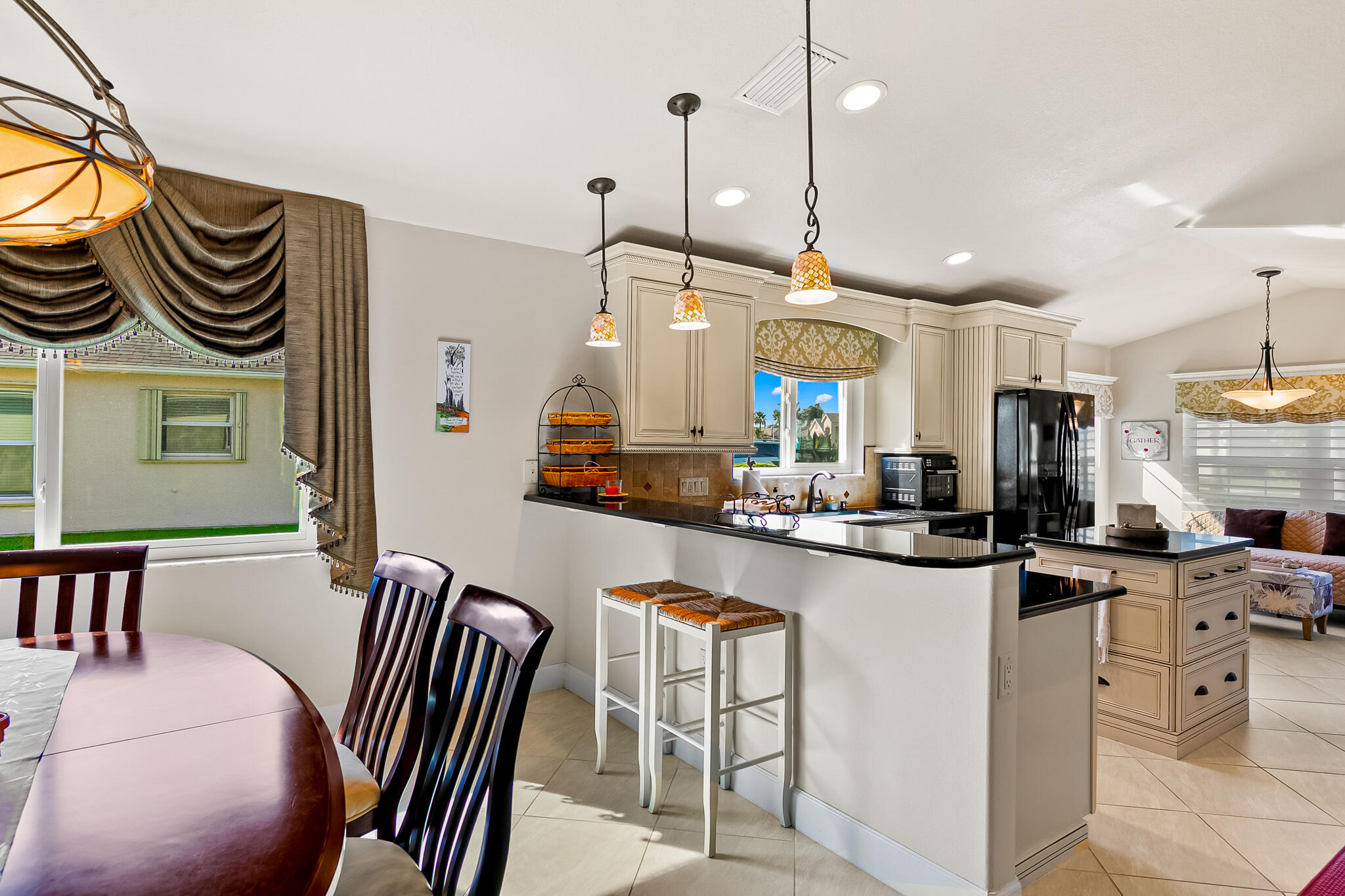 1605 Boca Rio Drive Melbourne, FL 32940 - Photo 9 of 55 a kitchen with stainless steel appliances granite countertop a sink a stove a refrigerator and island with wooden floor