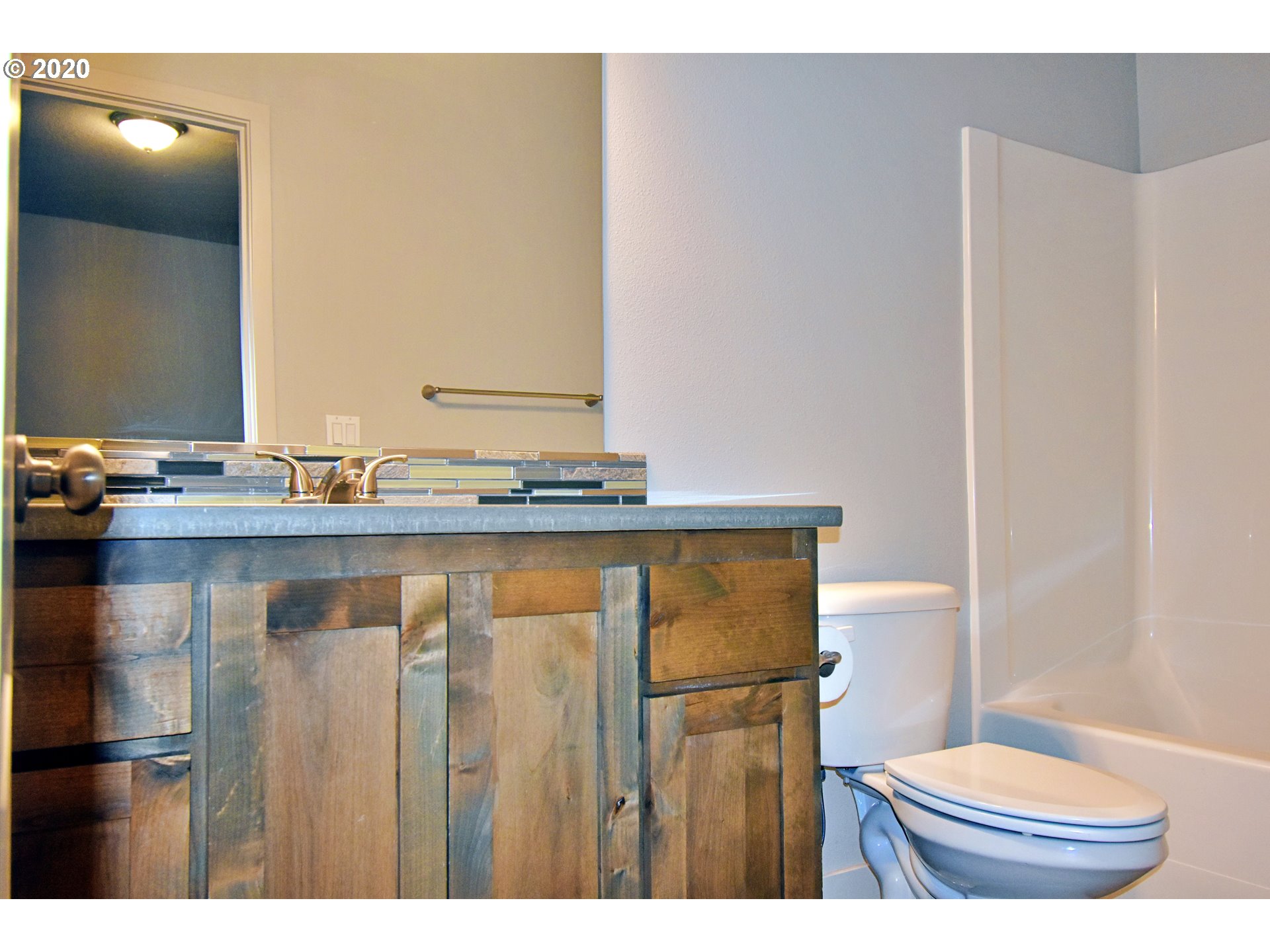 161 North 44th Place Ridgefield, WA 98642 - Photo 15 of 32 a bathroom with a granite countertop sink and a mirror