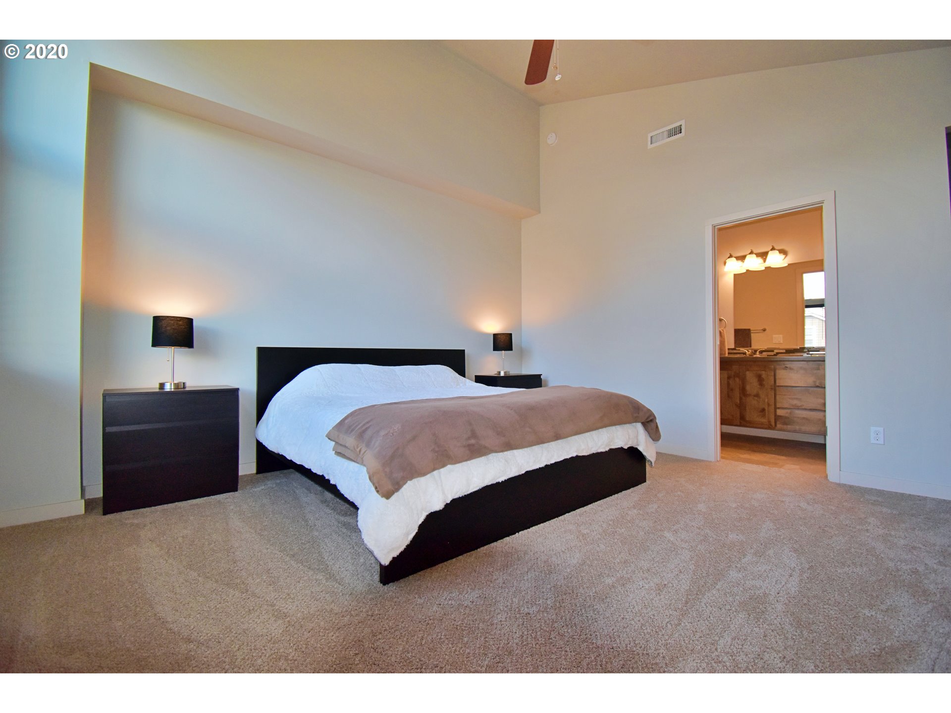 161 North 44th Place Ridgefield, WA 98642 - Photo 22 of 32 a bedroom with a bed and a lamp