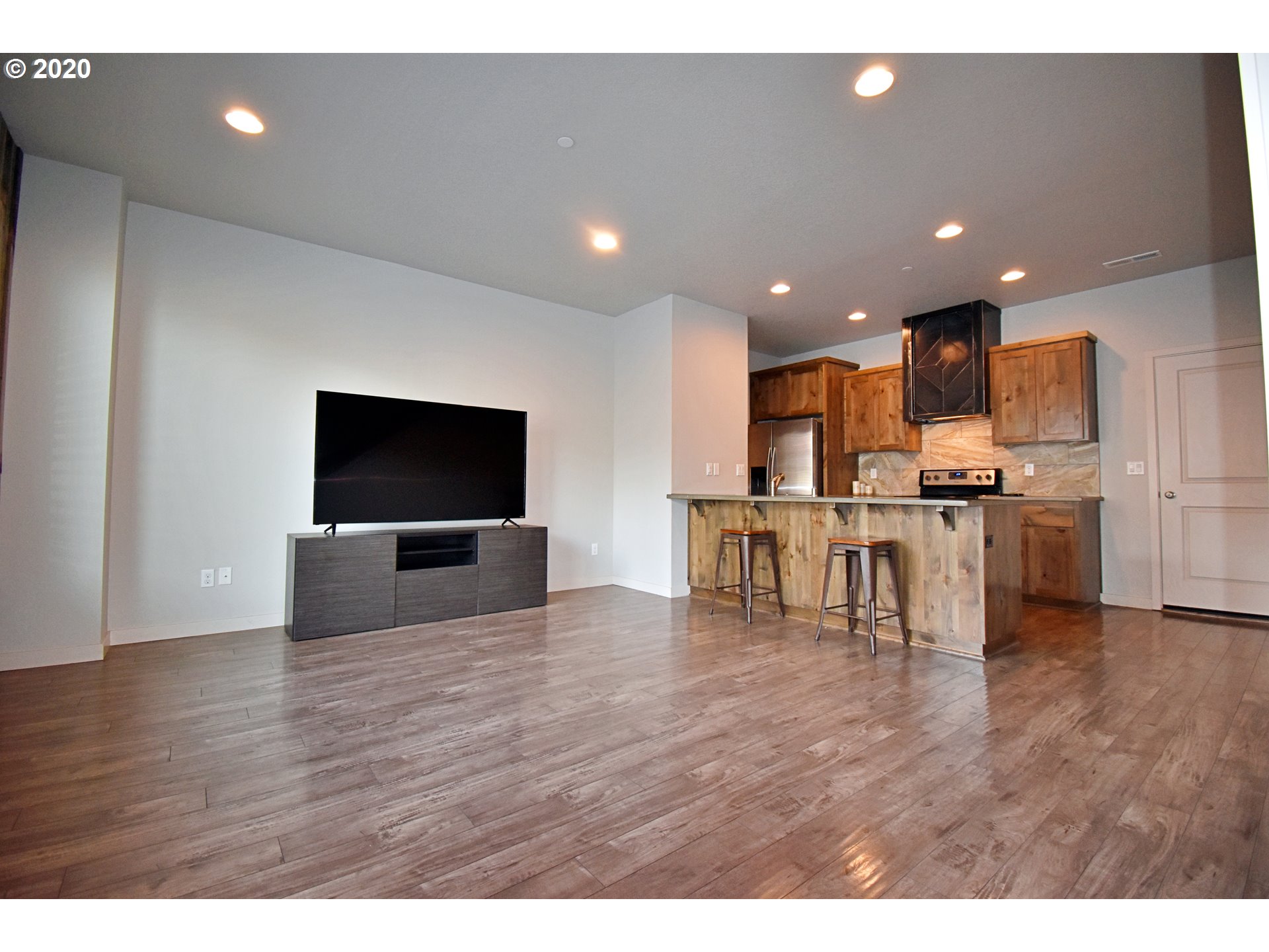 161 North 44th Place Ridgefield, WA 98642 - Photo 3 of 32 a living room with stainless steel appliances furniture and a flat screen tv