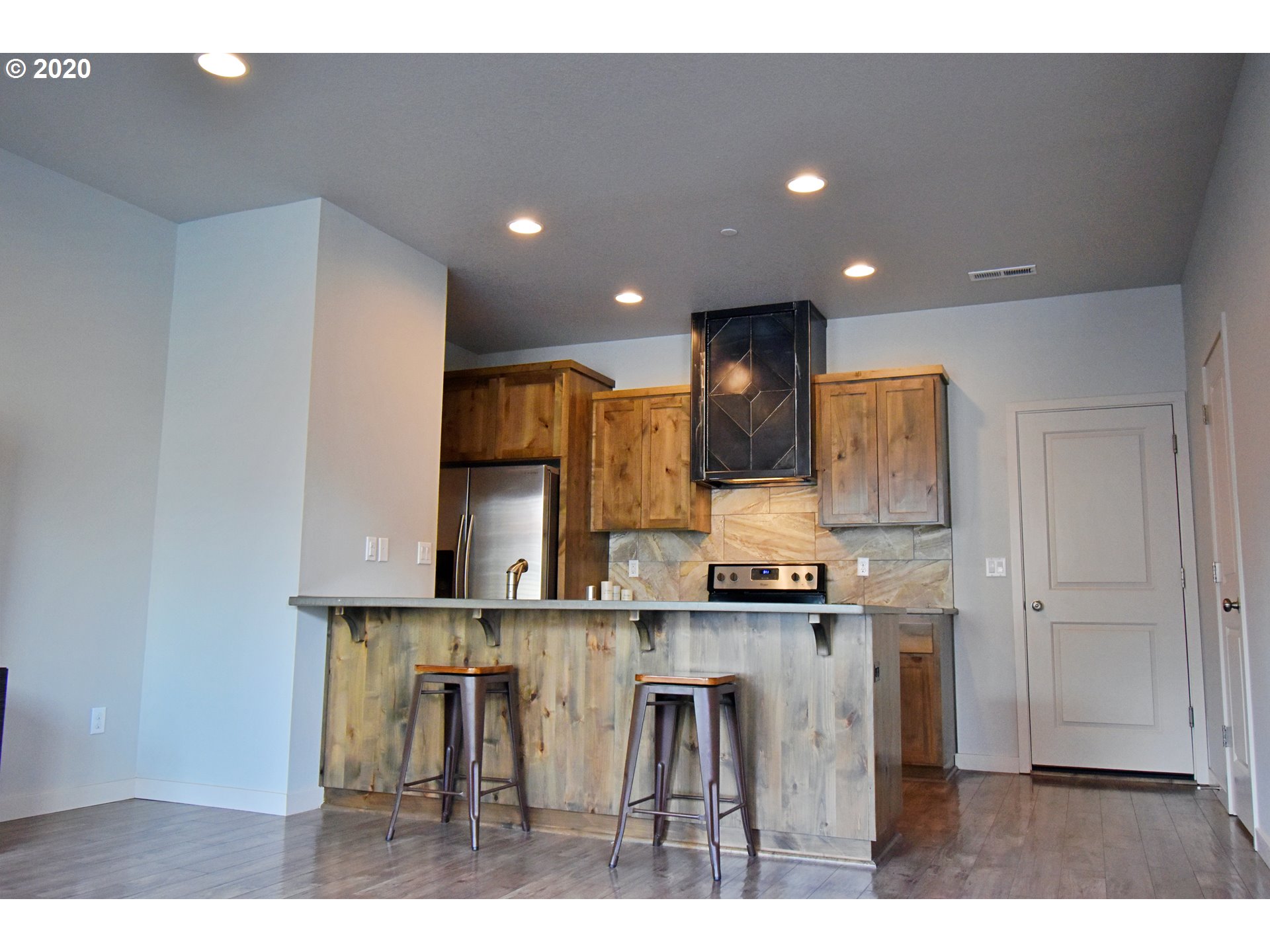 161 North 44th Place Ridgefield, WA 98642 - Photo 5 of 32 a kitchen with stainless steel appliances kitchen island a sink stove and cabinets
