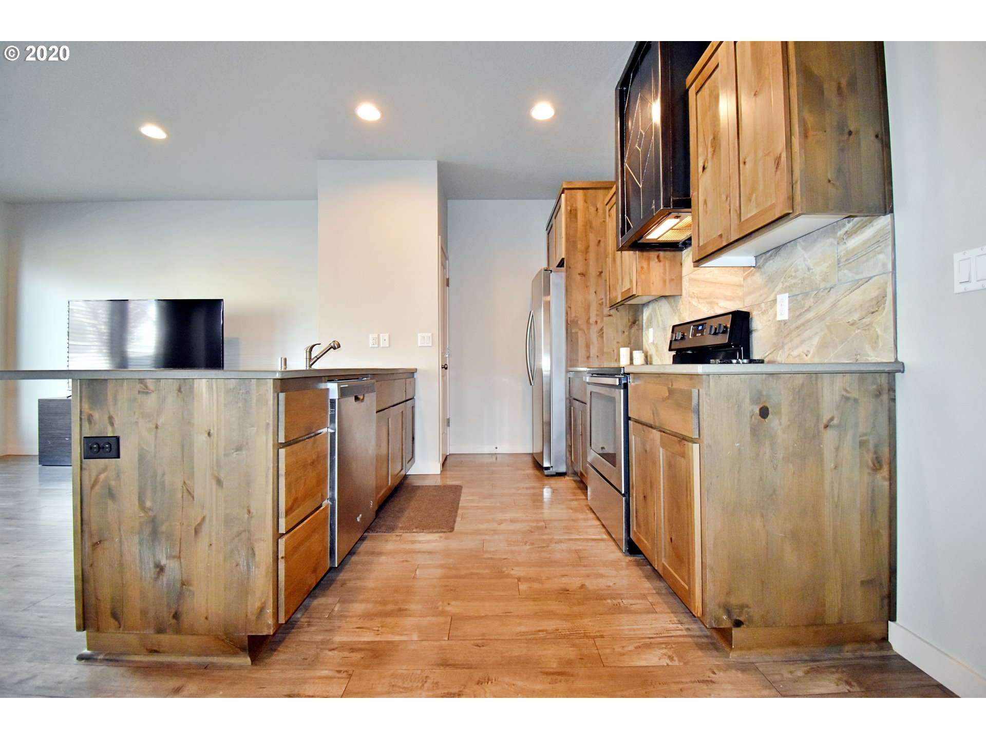 161 North 44th Place Ridgefield, WA 98642 - Photo 7 of 32 a kitchen with kitchen island a sink appliances and cabinets