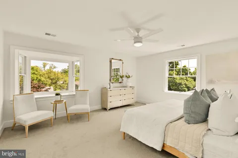 a bedroom with a large bed and a large window