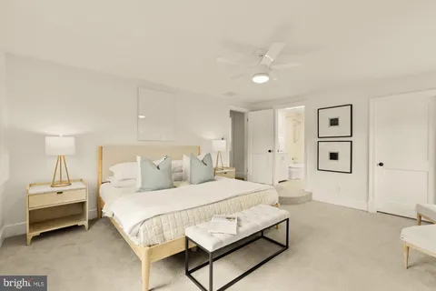 a bedroom with a bed lamp and a dresser