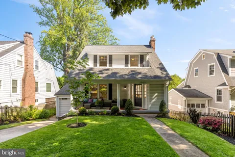 a view of house with a yard and potted plants