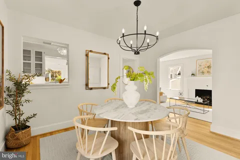 a view of a dining room with furniture wooden floor and chandelier