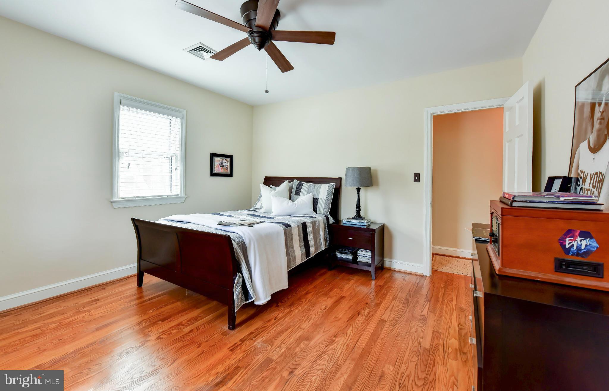 2806 Ridge Rd Drive Alexandria, VA 22302 - Photo 16 of 30 a bedroom with a bed a dresser and wooden floor