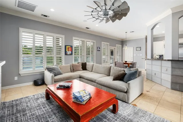 a living room with furniture a large window and a rug