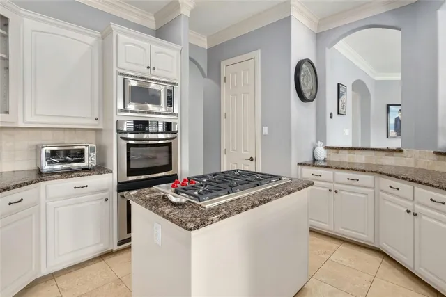 a kitchen with cabinets appliances and a counter space