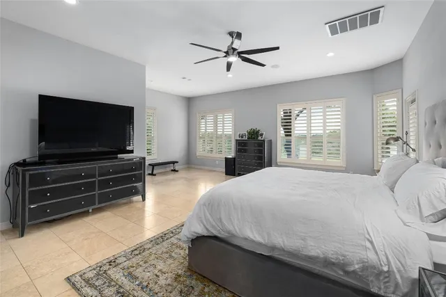 a bedroom with a bed and flat screen tv
