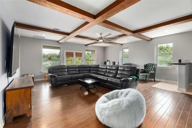 a living room with furniture and wooden floor