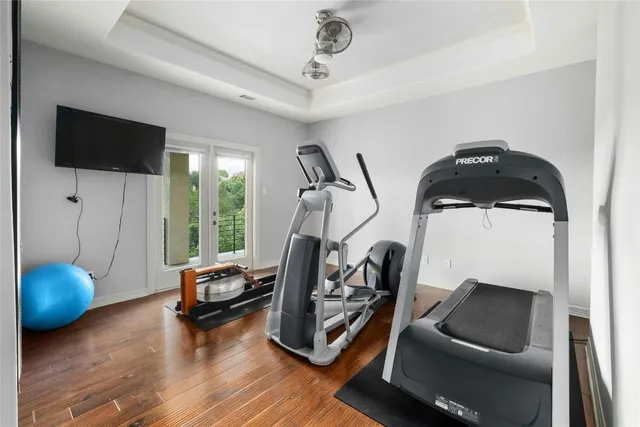 a living room with furniture a flat screen tv and a large window