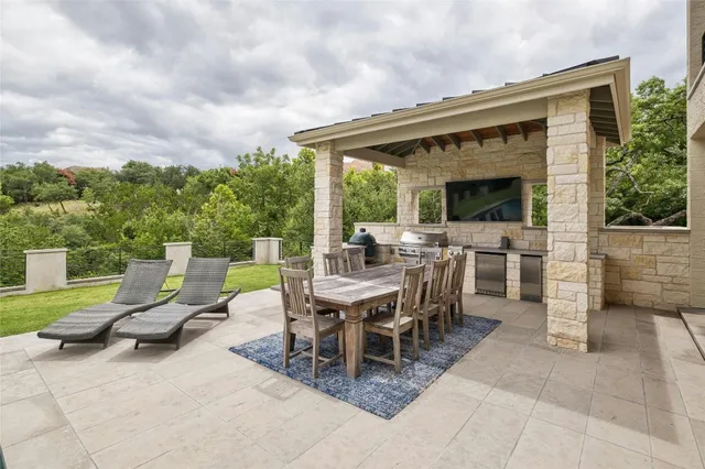 a view of a patio with a dining table and chairs