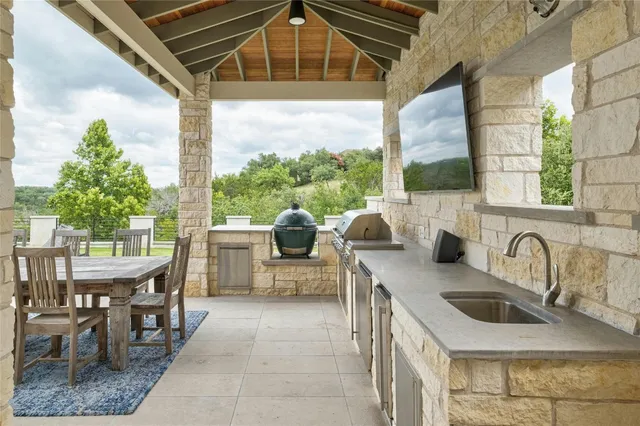 a kitchen with a sink a counter top space and stainless steel appliances