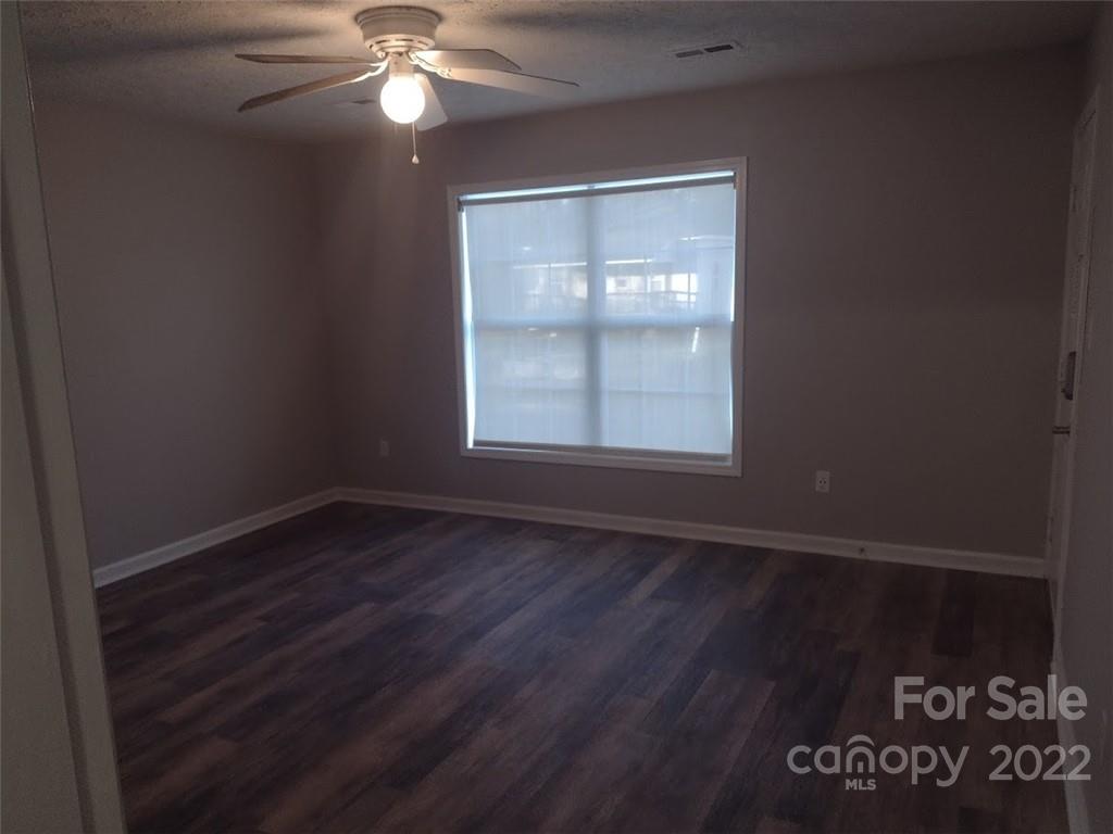 111 Sunset Drive Clover, SC 29710 - Photo 8 of 12 an empty room with wooden floor and windows