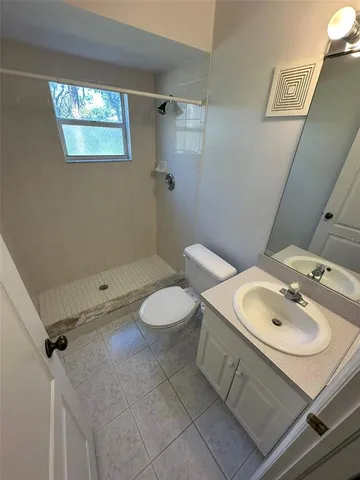 a bathroom with a sink toilet and mirror