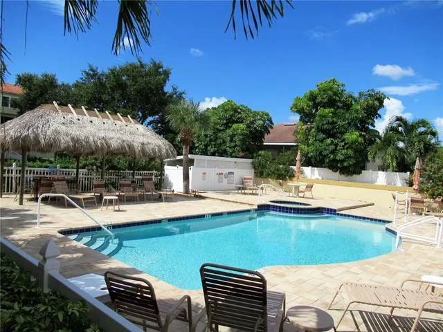 a view of a swimming pool with lounge chairs