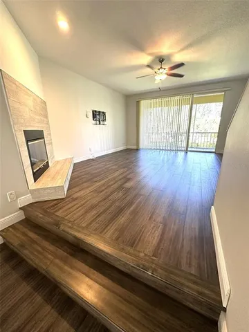 a view of an empty room and wooden floor