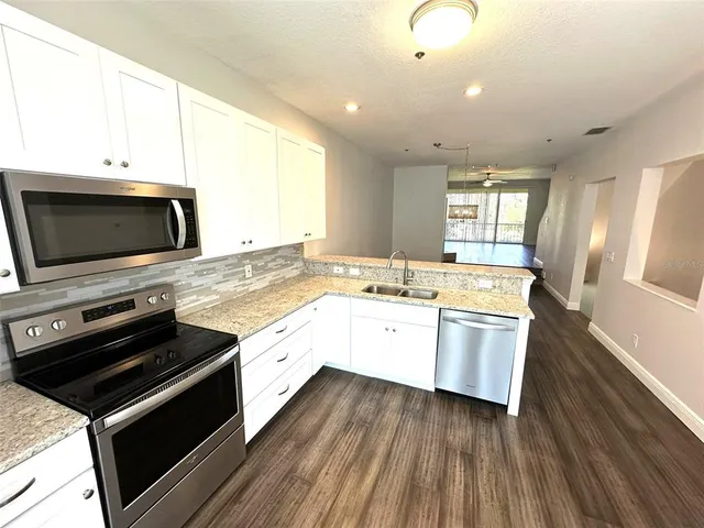 a kitchen with a sink stove and microwave