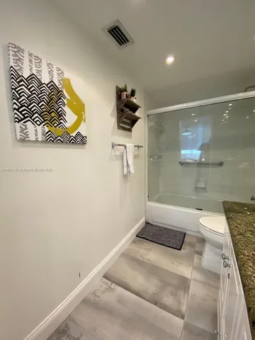 a bathroom with a bathtub and shower