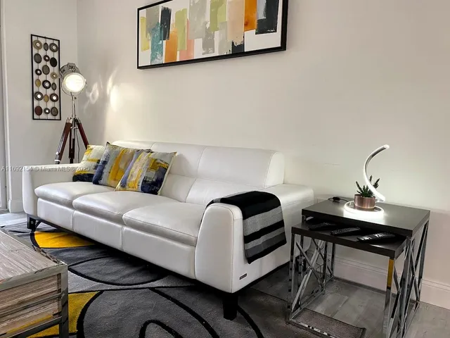 a living room with furniture and a lamp