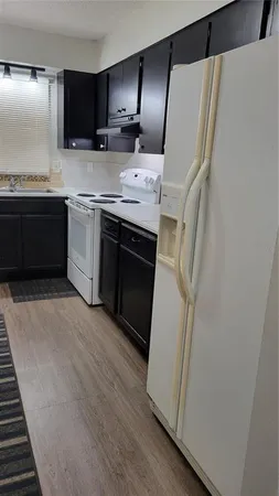a kitchen with stainless steel appliances a sink and a refrigerator