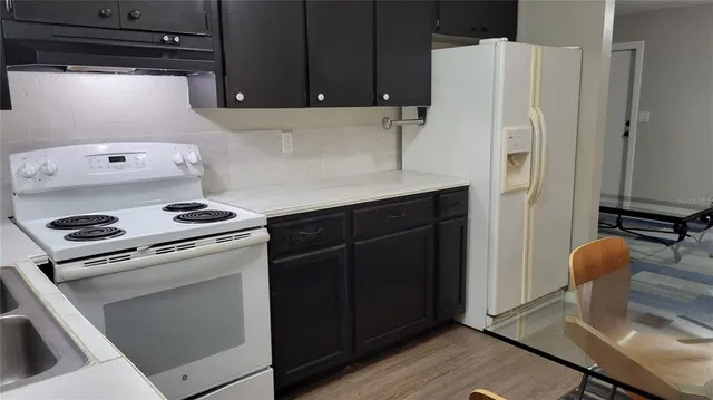 a kitchen with appliances and cabinets