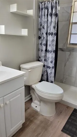 a white toilet sitting next to a bathroom sink