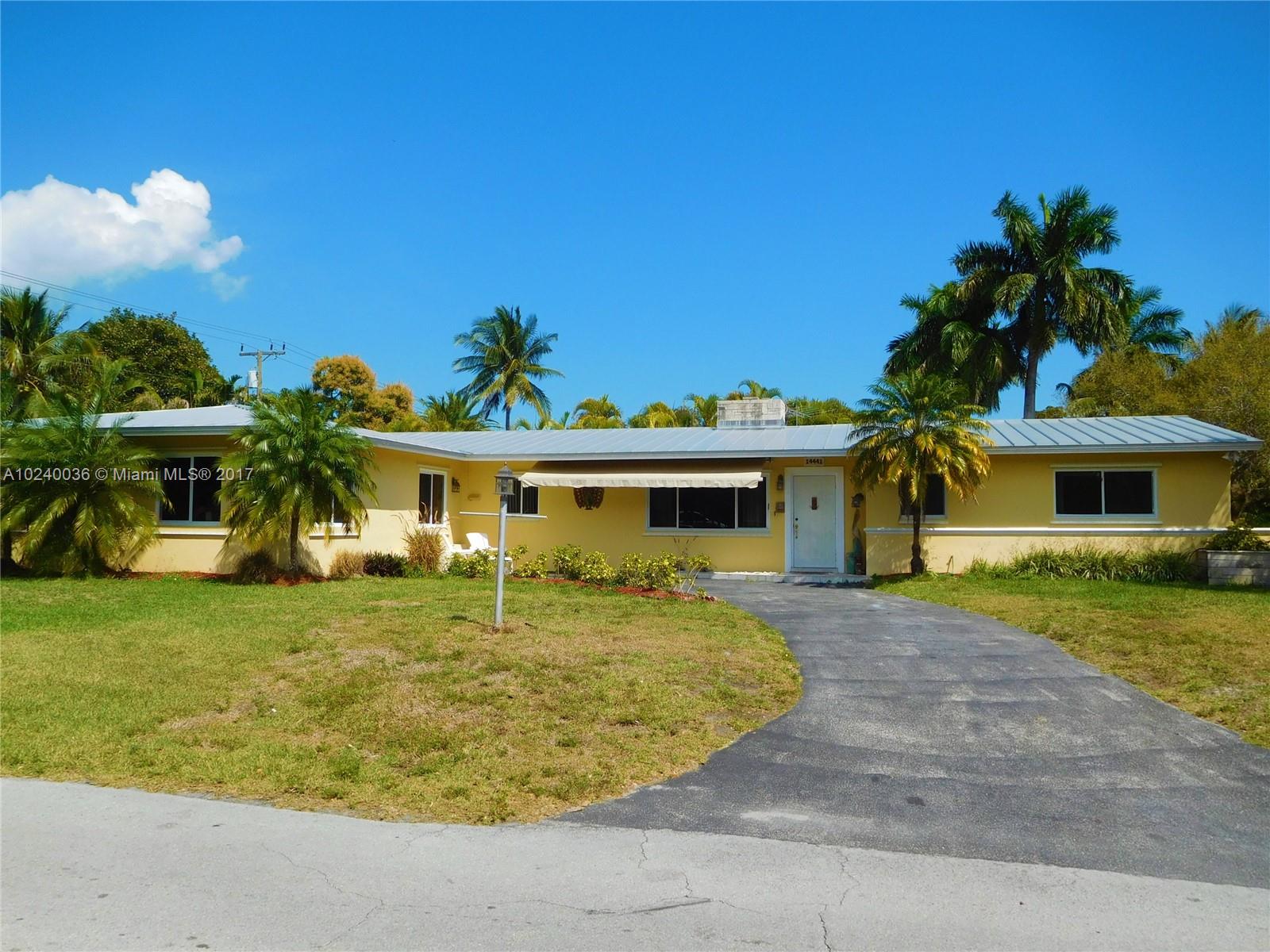 14441 Snapper Drive Coral Gables, FL 33158 - Photo 1 of 27 a front view of a house with garden