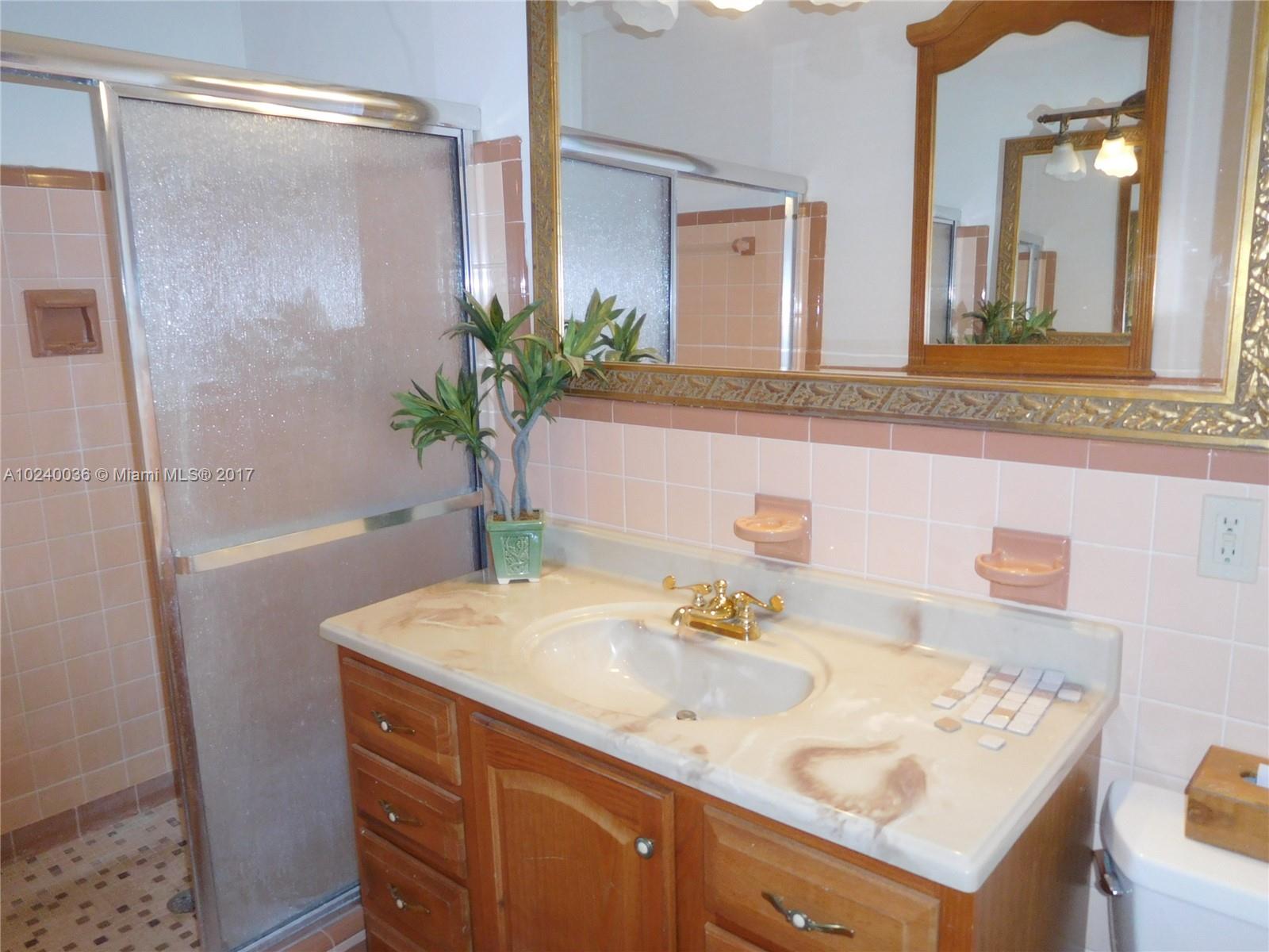 14441 Snapper Drive Coral Gables, FL 33158 - Photo 11 of 27 a bathroom with a sink and a mirror